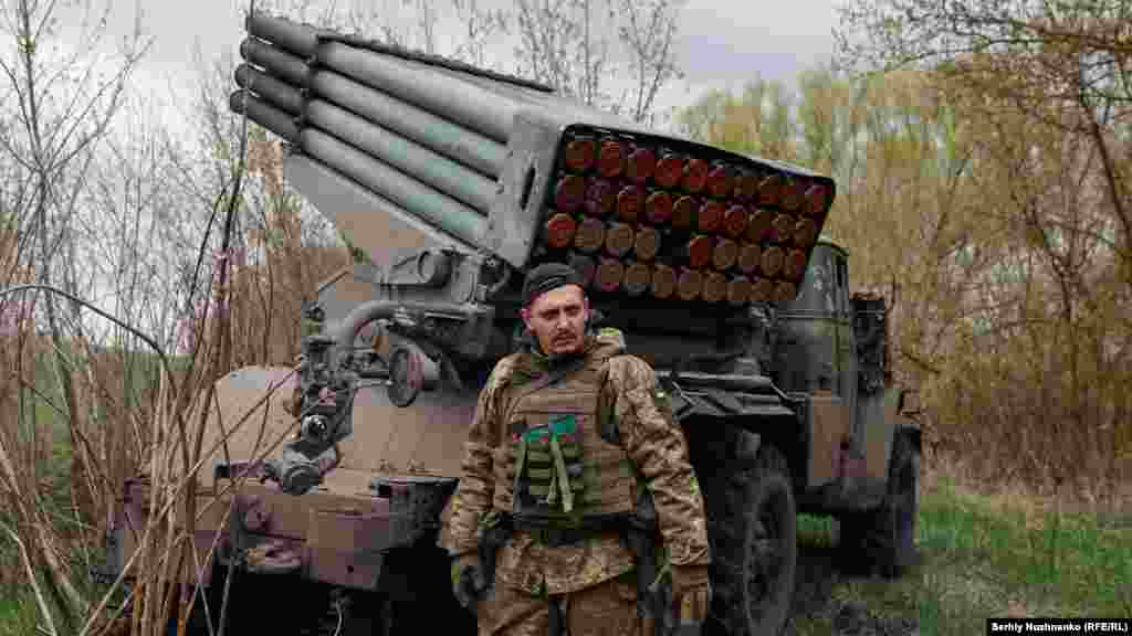 A Ukrainian soldier stands near a Grad multiple-launch rocket system on April 20, 2022.