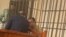 Ukrainian citizen Volodymyr Kadaria in a defendant's cage in a Bishkek courtroom on March 1.
