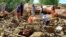 Afghans search through a building destroyed by heavy flooding earlier this month. Afghanistan has suffered a series of disastrous inundations this year