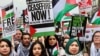 People take part in a protest calling for a cease-fire amid the ongoing conflict between Israel and the Palestinian Islamist group Hamas, which has been designated a terrorist group by the EU and United States, in London on February 17.
