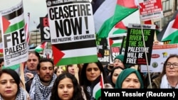 People take part in a protest calling for a cease-fire amid the ongoing conflict between Israel and the Palestinian Islamist group Hamas, which has been designated a terrorist group by the EU and United States, in London on February 17.