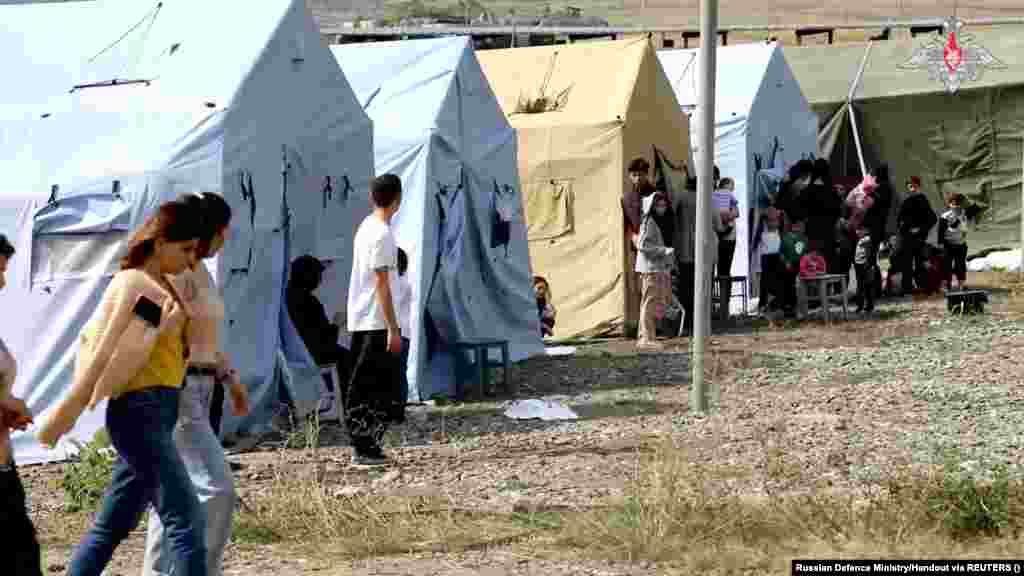 An image released by the Russian Defense Ministry on September 21 reportedly shows civilians evacuated by Russian peacekeepers at an undisclosed location. Azerbaijan halted its military action in the breakaway region of Nagorno-Karabakh on September 20 after its swift battlefield success forced Armenian separatists to agree to a cease-fire that would see the area fully return to Baku&#39;s control.