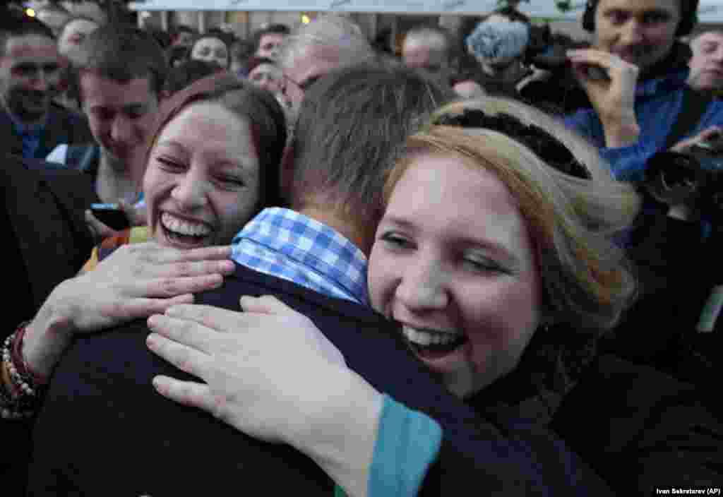 Jubilant supporters embrace Navalny in May 2012 after he and left-wing politician Sergei Udaltsov were released from detention after serving a 15-day sentence for &quot;participating in an illegal public event&quot; in Moscow. The two were arrested as they protested Putin&#39;s inauguration.