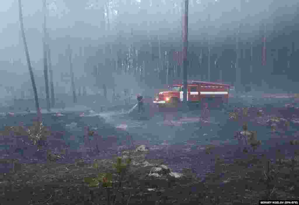 Ukrainian rescuers work to extinguish a fire in a forest after shelling in the city of Bogodukhiv, Kharkiv region, northeastern Ukraine.