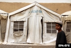 A tent donated by UNICEF served as a venue for an informal literacy class in rural Kandahar.