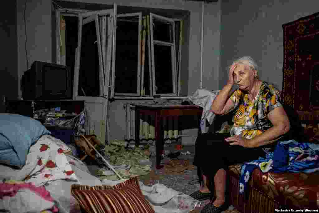 &nbsp;A wounded woman sits in her damaged apartment. The deadly attack came just a day after officials from around 40 countries gathered in Saudi Arabia to find a peaceful settlement to the war in Ukraine.