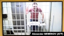 Russian opposition figure Ilya Yashin is seen on a screen via video link during a court hearing to consider an appeal on his prison sentence for discrediting the Russian Army fighting in Ukraine, in Moscow on April 19.