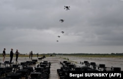 Ukrainian operators fly DJI drones at a training area in August.