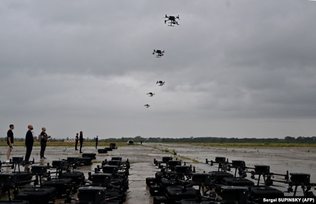 Ukrainian operators fly DJI drones at a training area in August.