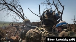 Ukrainian soldiers fire toward Russian positions from a trench on the front line in the Zaporizhzhya region last week.