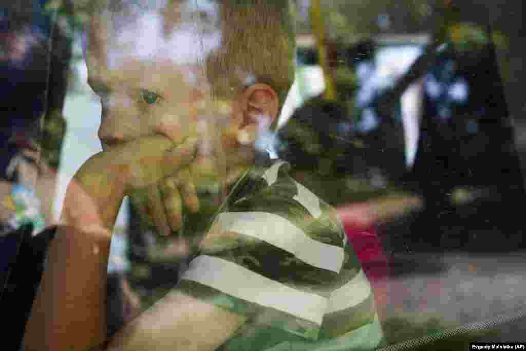 A boy looks out the window of a bus during evacuations in Pokrovsk, Donetsk region, Ukraine.