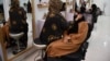 An Afghan beautician applies makeup to a client at a beauty salon in Mazar-e Sharif on July 5.