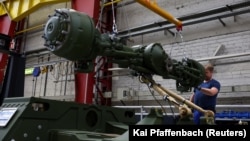 A man works on an assembly line for German weapons manufacturer Rheinmetall. 