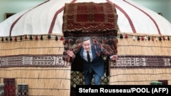 Cameron pops out of a yurt at the National Carpet Museum in Ashgabat on April 24.