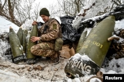 A Ukrainian soldier prepares 155 mm artillery shells at a position near the front line, amid Russia's attack on Ukraine, in the Zaporizhzhya region on January 14.