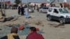 Security officials examine the scene of a bomb blast in Pakistan&#39;s Balochistan Province on February 7. Two bomb blasts killed more than 20 people and are raising concerns over security in the nuclear-armed South Asian country as it prepares for a general election.