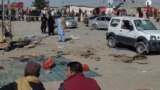 Security officials examine the scene of a bomb blast in Pakistan&#39;s Balochistan Province on February 7. Two bomb blasts killed more than 20 people and are raising concerns over security in the nuclear-armed South Asian country as it prepares for a general election.