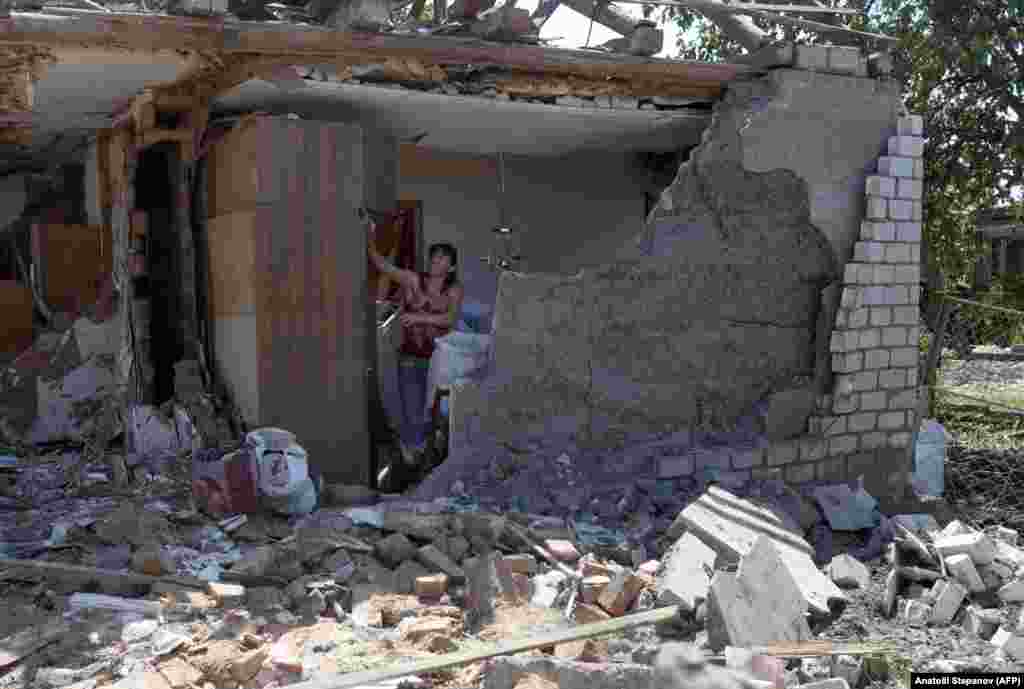 A resident salvages belongings from the remains of her home in the aftermath of a Russian attack on Kramatorsk, Ukraine.