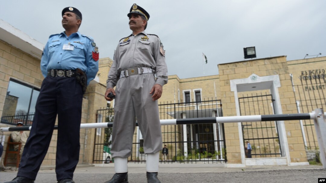 Pakistani policemen stand in front of the Election Commission of Pakistan (ECP) office in Islamabad. 