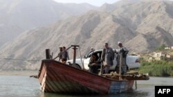 A ferry boat loaded with a car crosses a river on the outskirts of Fayzabad, Badakhshan Province. (illustrative photo)