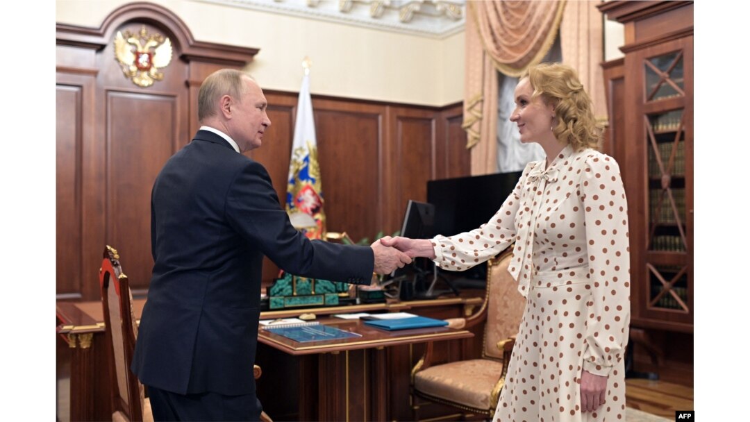 Russian President Vladimir Putin and Children's Rights Maria Lvova-Belova, both wanted for arrest by the ICC, meet at the Kremlin on March 9, 2022.
