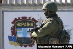 Российский военный рядом с украинской военно-морской базой в Крыму. Симферополь, 3 марта 2014 года