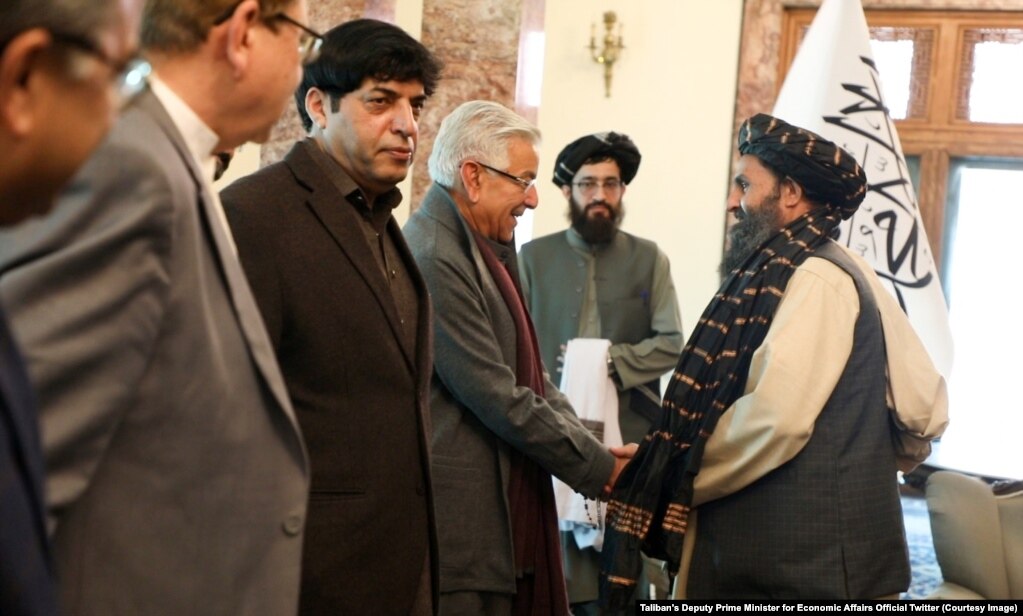 The Afghan Taliban's acting deputy prime minister, Mullah Baradar (right), meets a Pakistani delegation led by then-Defense Minister Khwaja Asif (left) in Kabul in February.