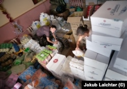 Volunteers sort through supplies in a village near Avdiyivka.