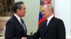 Russian President Vladimir Putin (right) greets Chinese Communist Party foreign policy chief Wang Yi during their meeting at the Kremlin in Moscow on February 22.