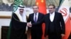 Chinese Foreign Minister Wang Yi (center) poses with Ali Shamkhani, secretary of Iran's Supreme National Security Council (right) and Saudi Arabia's national security adviser, Musaad bin Muhammad al-Aiban (left), in Beijing on March 10.