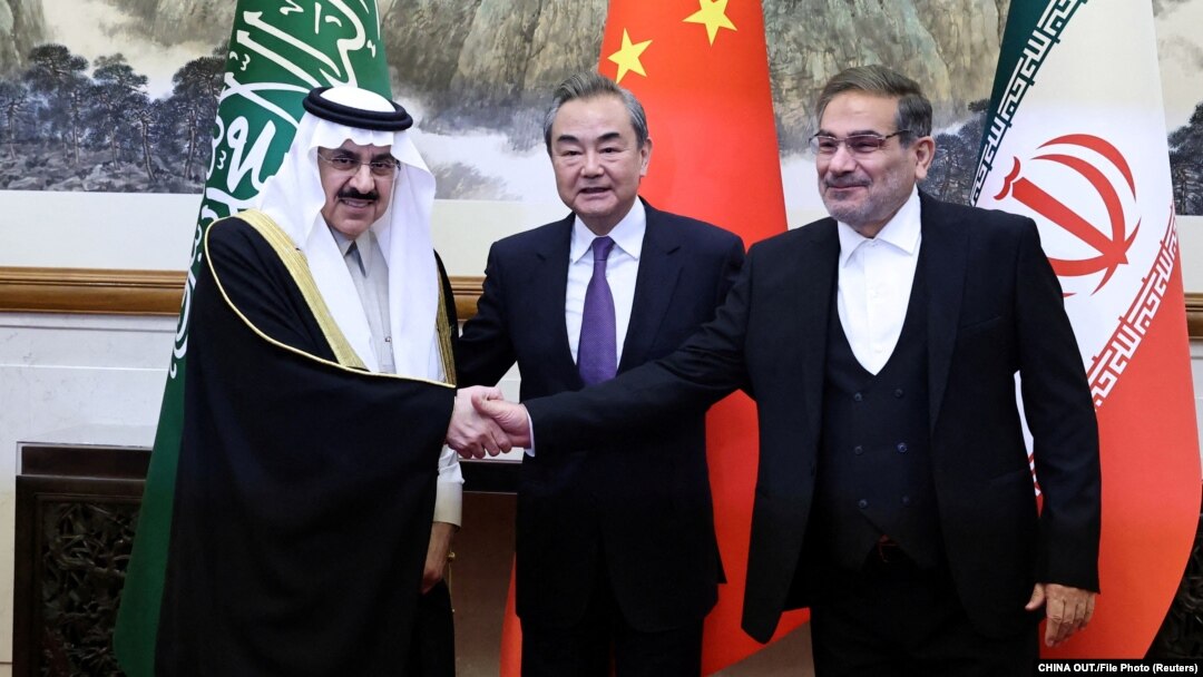 Chinese Foreign Minister Wang Yi (center) poses with Ali Shamkhani, secretary of Iran's Supreme National Security Council (right) and Saudi Arabia's national security adviser, Musaad bin Muhammad al-Aiban (left), in Beijing on March 10.