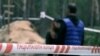 Izyum, Ukraine -- A blurred shot of a journalist of RFE/RL's Ukrainian service interviewing a witness of possible war crimes