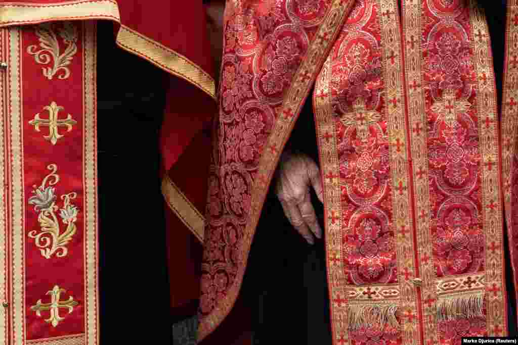 Priests wearing ceremonial robes stood by as&nbsp;Porfirije held the service.