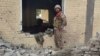 An Pakistani soldier examines the damage at the site of a bombing of a police station on the outskirts of Dera Ismail Khan on December 12.