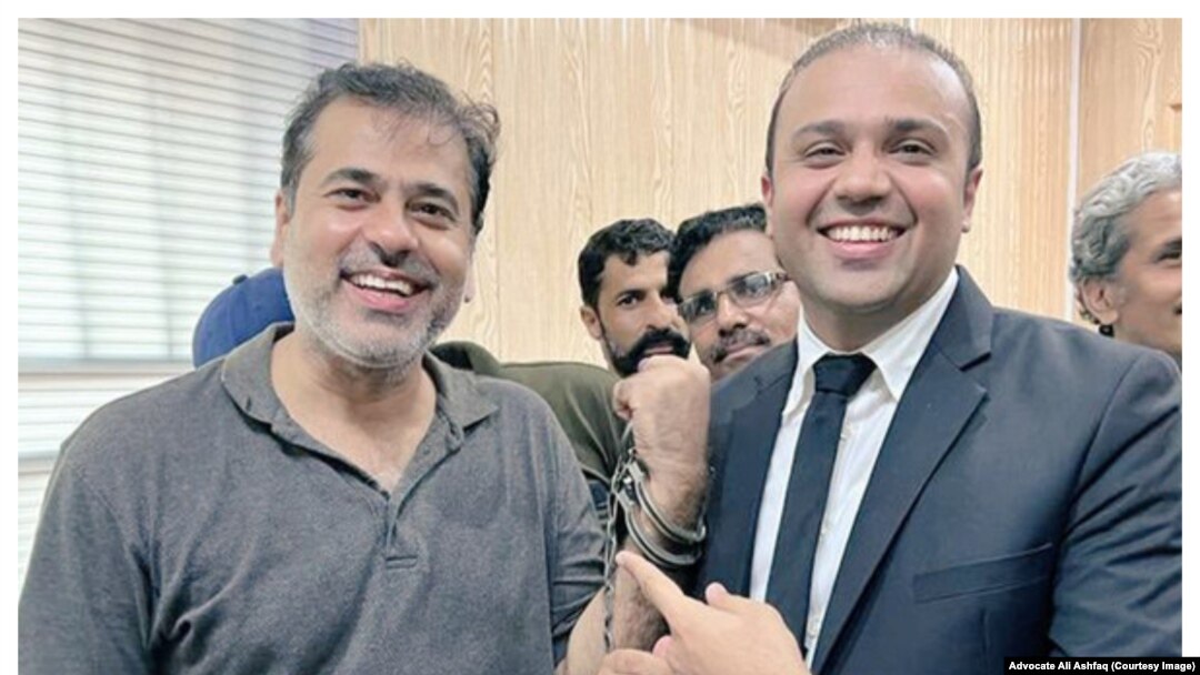 Pakistani journalist Imran Riaz Khan alongside his lawyer Ali Ashfaq