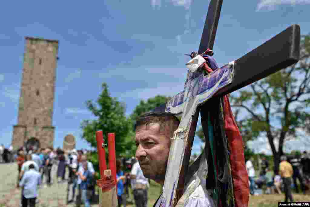 Serb nationals hold icons as they take part in a ceremony marking the historic Battle of Kosovo at the Gazimestan monument on the outskirts of Pristina on June 28. The 1389 Battle of Kosovo, fought on June 28, was a pivotal confrontation between the forces of the Serbian Prince Lazar Hrebeljanovic and the Ottoman Empire led by Sultan Murad I.