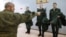 Russian conscripts try on uniforms at a local draft office before departing for military service. (file photo)