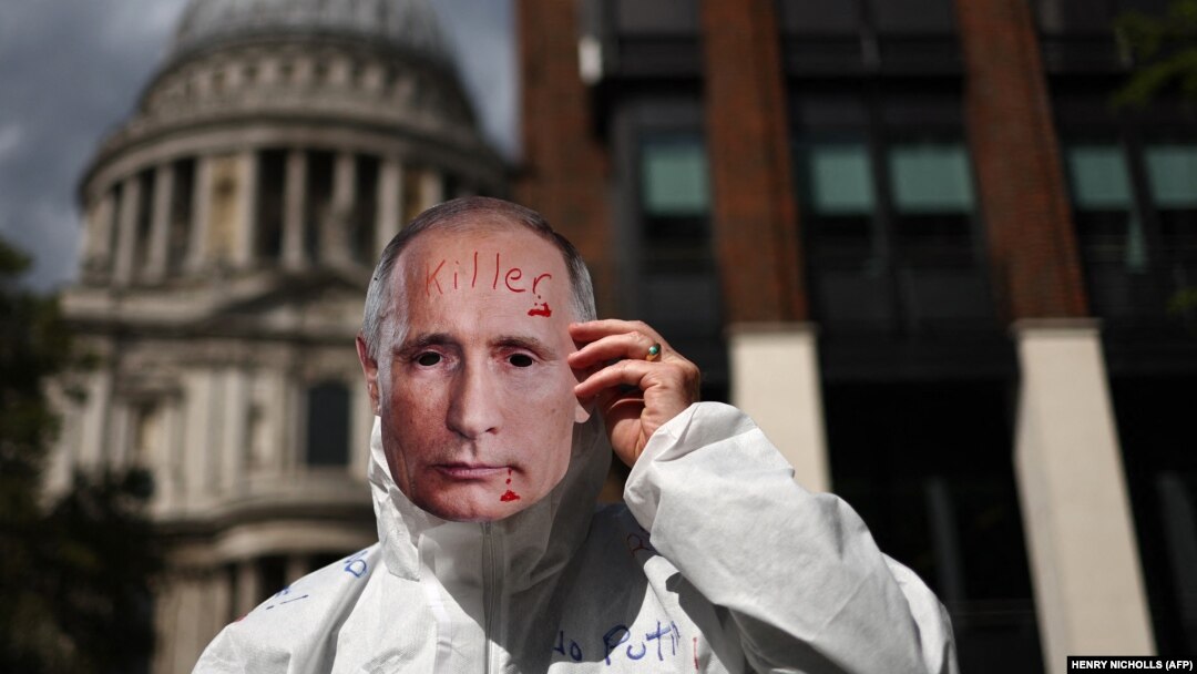 A protester with a face mask of Russian President Vladimir Putin takes part in a rally in London as part of the International "Putin Is A Killer" day of action across Europe on August 20.
