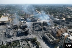 На снимке с воздуха показаны разрушенные здания в городе Аль-Захра к югу от города Газа 20 октября 2023 года после ночной израильской бомбардировки на фоне продолжающихся боев между Израилем и палестинской группировкой ХАМАС.