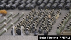 Kosovar police display weapons confiscated during searches in a northern, ethnic Serb-dominated district where an attack on an Orthodox monastery in September left four people dead, including a police officer. (Bujar Terstena, RFE/RL's Balkan Service)