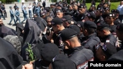 Armenia - Riot police confront Catholicos Garegin II and other top clergymen at Sardarapat memorial, May 28,. 2024.