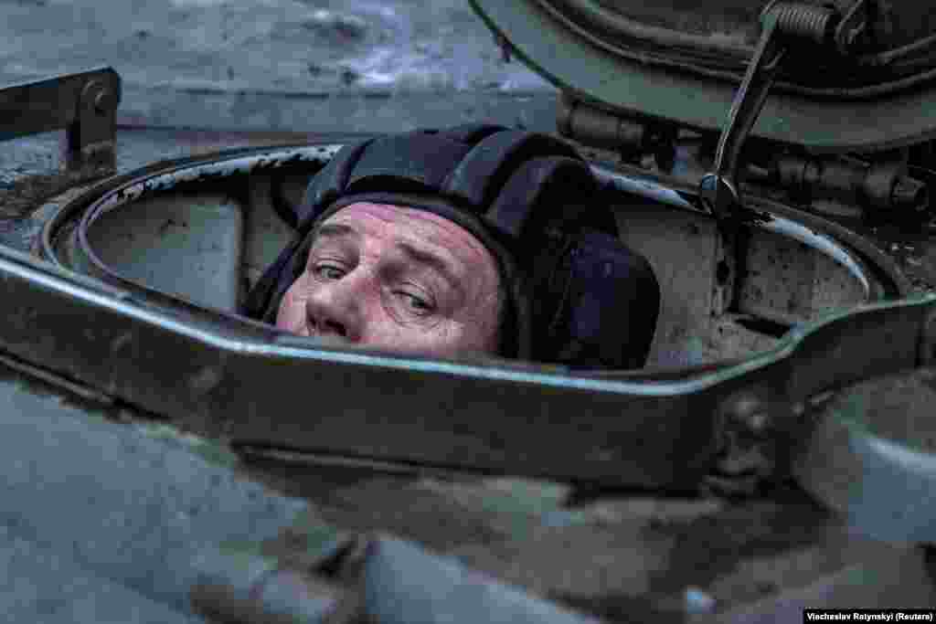 A soldier peers above his hatch on the Gvozdika as his unit prepares for action.