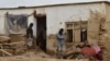 Afghan men clear debris and mud from a damaged house after a flash flood caused by heavy rainfall in Laqiha village of Baghlan-e Markazi district in the northern Baghlan Province on May 11.