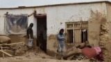Afghan men clear debris and mud from a damaged house after a flash flood caused by heavy rainfall in Laqiha village of Baghlan-e Markazi district in the northern Baghlan Province on May 11.