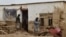 Afghan men clear debris and mud from a damaged house after a flash flood caused by heavy rainfall in Laqiha village of Baghlan-e Markazi district in the northern Baghlan Province on May 11.