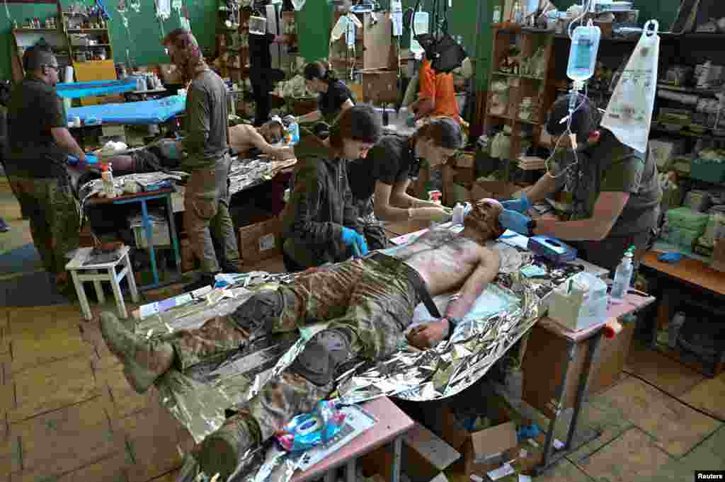 Medics help injured Ukrainian soldiers inside a frontline medical-stabilization point amid Russia&#39;s attack on Ukraine.