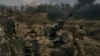 Ukrainian soldiers fire a howitzer toward Russian positions near Bakhmut in the eastern Donetsk region on March 7.