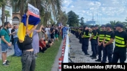 Protesters held banners with slogans decrying Russia's war in Ukraine and President Vladimir Putin for launching the invasion.