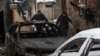 Ljudi iznose tijelo iz zapaljene kuće na mjestu napada ruskih dronova, usred ruskog napada na Ukrajinu, u Harkivu, Ukrajina, 10. februara 2024.