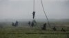 Polish soldiers from 25th Air Cavalry Brigade land during the Defender Europe 2022 military exercise of NATO troops at the military range in Bemowo Piskie, near Orzysz, Poland, on May 24, 2022.